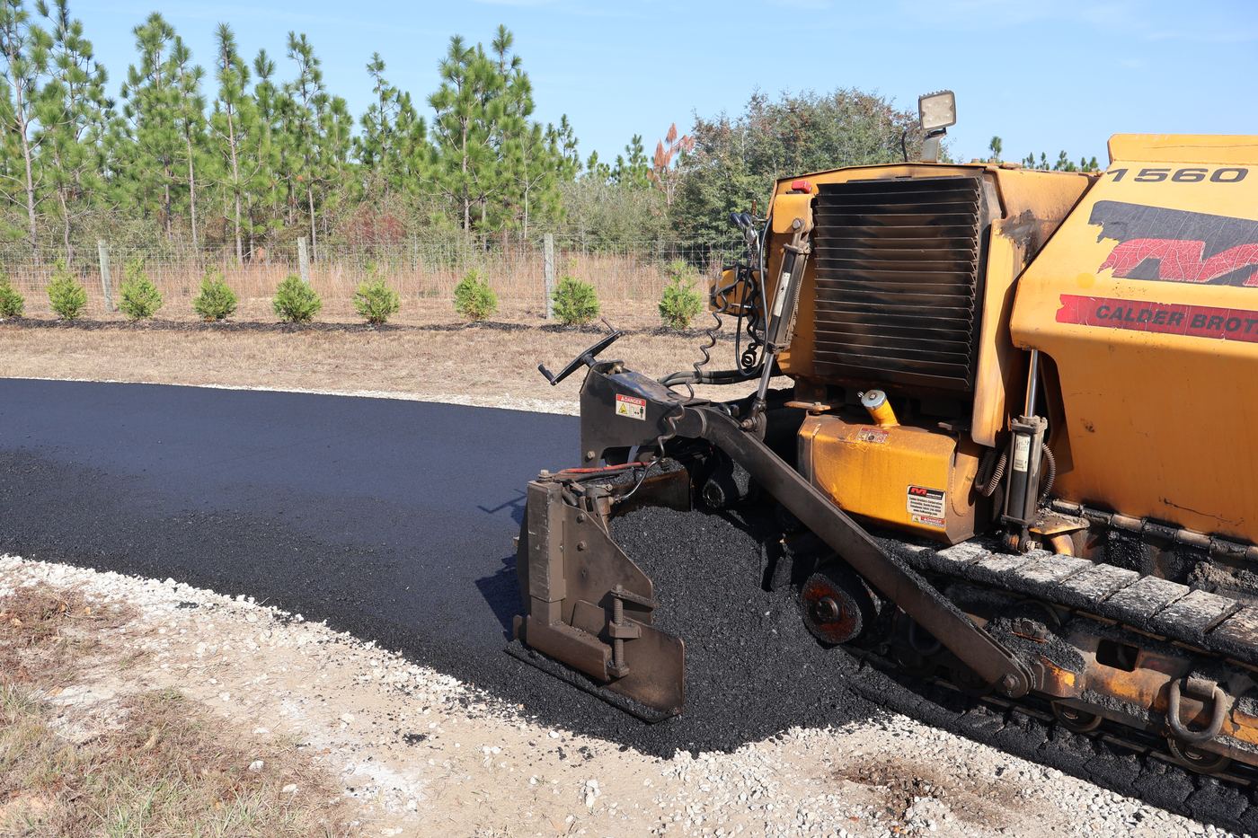 Paving machine laying fresh asphalt