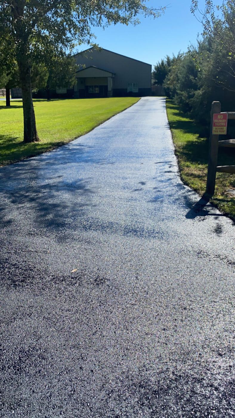 Wet black finish on a freshly sealed driveway